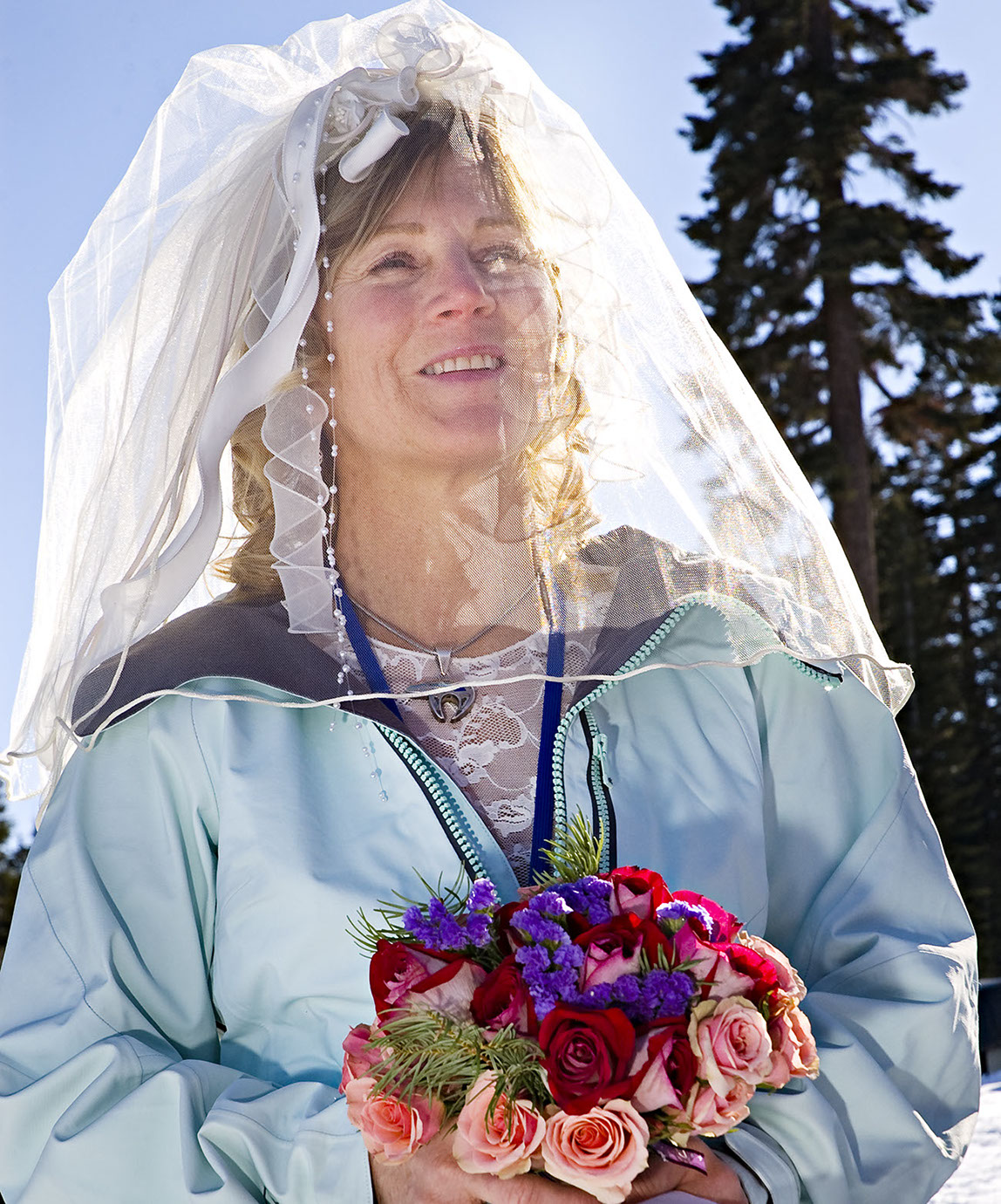 Boston Wedding Photographer Ron Richman photographs The smiling bride with flowers and sun light shining through her vail looking fantastic.