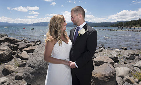 Boston Photographer shoots a Lake Tahoe Wedding. Bride in a gorgeous white dress locking eyes with her groom with Lake Tahoe as the bacckdrop.