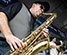 Master Photographer Ron Richman photographed these muscians and singers at the Concerts At Commons Beach. Close up of sax player. Joy & Madness