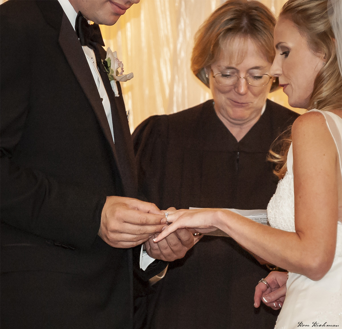 Boston Wedding Photographer Ron Richman photographs the groom putting the diamond ring on her finger.